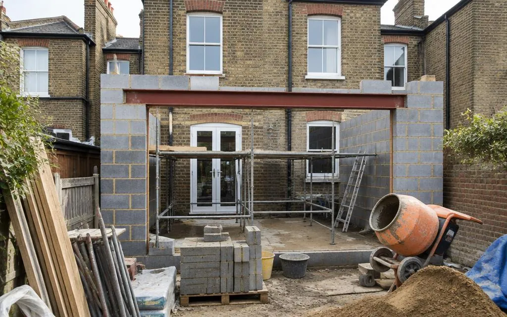 Rear extension under construction with a steel beam over the rear opening